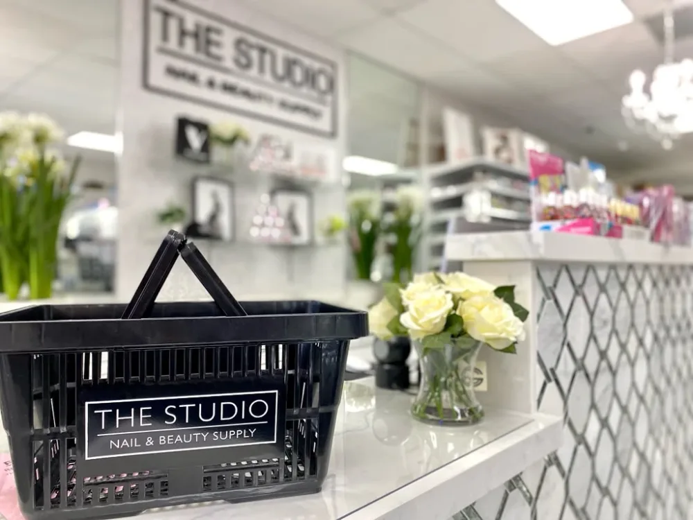The Studio Nail & Beauty Supply shopping basket on the counter inside the store